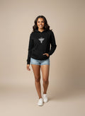 Woman wearing a black Sabio hoodie with a logo 