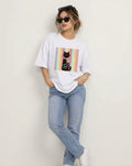 Relaxed street style fit featuring The Sabio oversized white graphic t-shirt paired with classic denim.