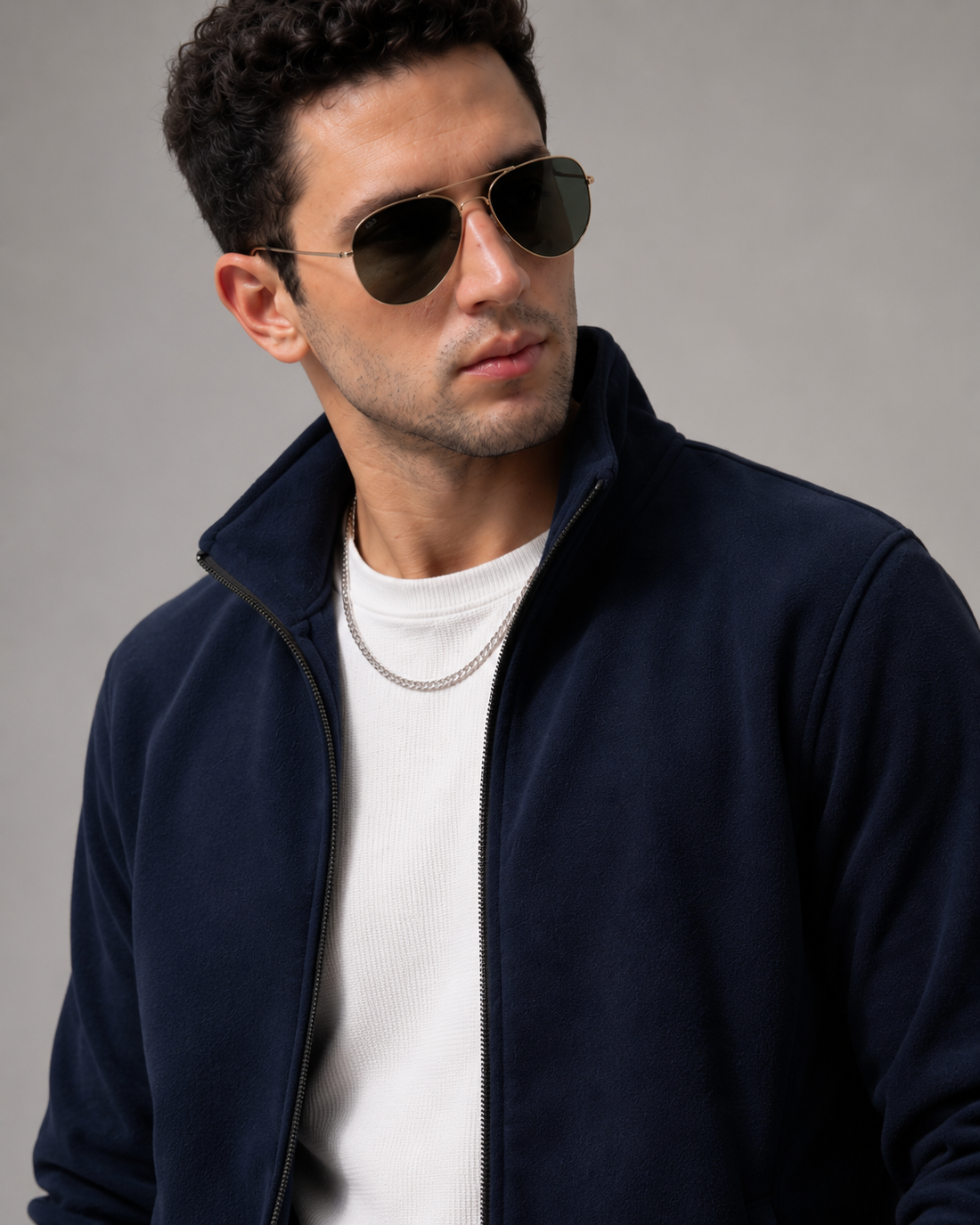 A navy blue zip-up fleece jacket with a stand-up collar, side pockets, and elasticized cuffs, shown on a plain white background.