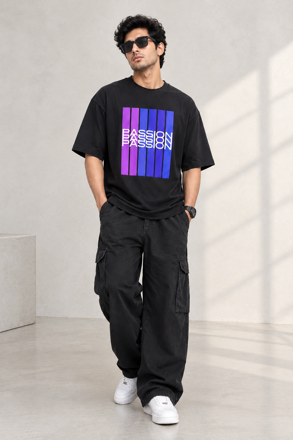A black short-sleeve crewneck t-shirt with a graphic on the chest featuring vertical purple and magenta stripes with the word 'PASSION' printed in white across them, displayed on a light beige background.