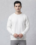 Full body styling of The Sabio solid white crewneck sweatshirt paired with relaxed grey denim and white sneakers.