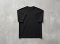 The Sabio premium 240 GSM black heavyweight oversized t-shirt laid flat on a textured raw concrete background.