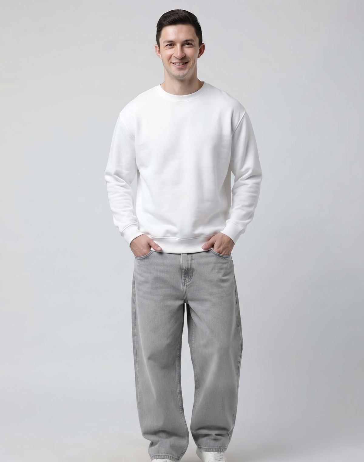 Male model wearing The Sabio solid white relaxed crewneck fleece sweatshirt, front close-up view.