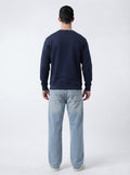 Full back view of male model in The Sabio structured navy blue fleece sweatshirt showing clean back yoke detailing.