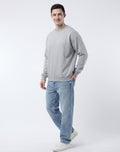 Back view of model wearing The Sabio relaxed fit crewneck sweatshirt in heather grey showing clean back yoke and ribbed cuffs.