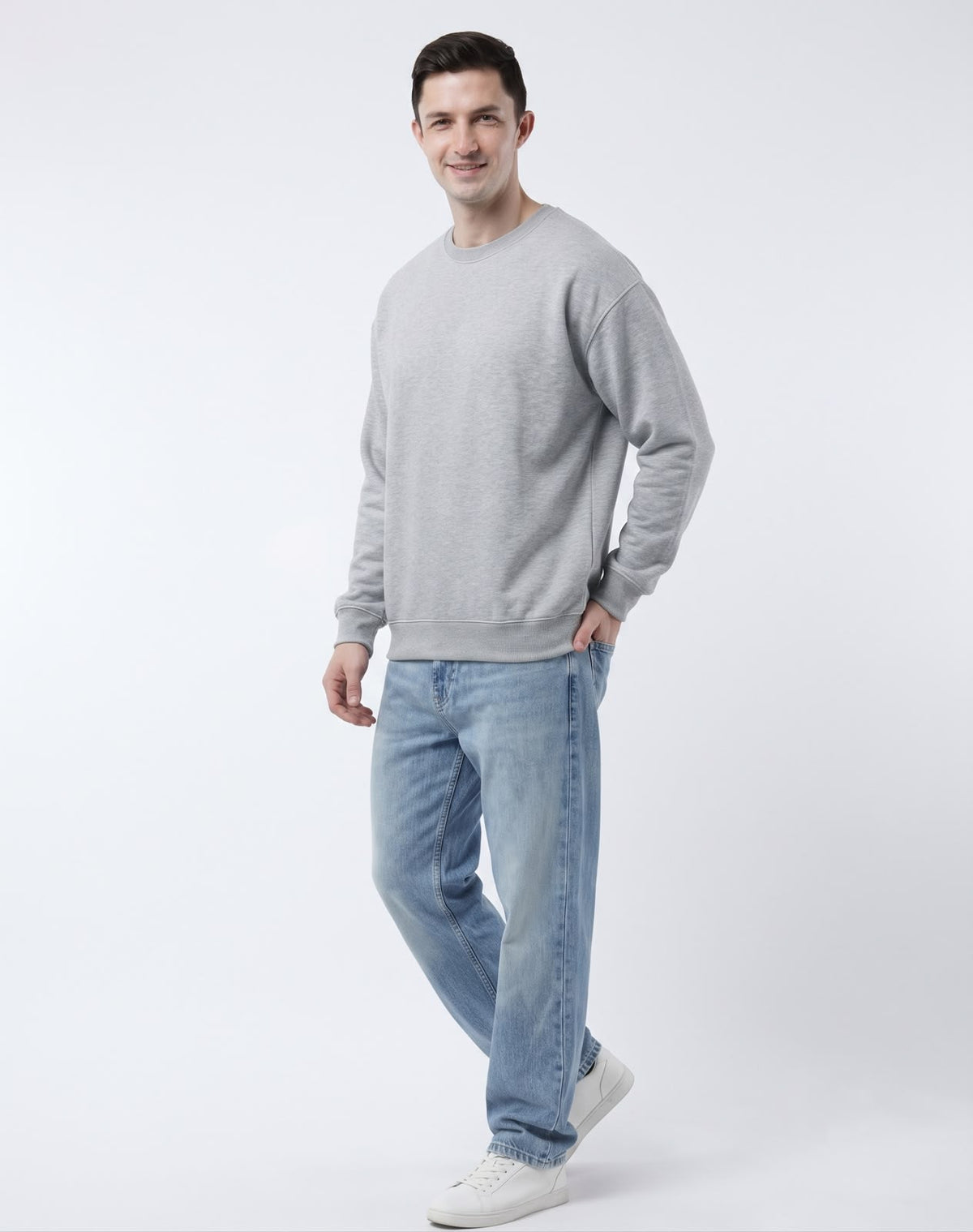 Back view of model wearing The Sabio relaxed fit crewneck sweatshirt in heather grey showing clean back yoke and ribbed cuffs.
