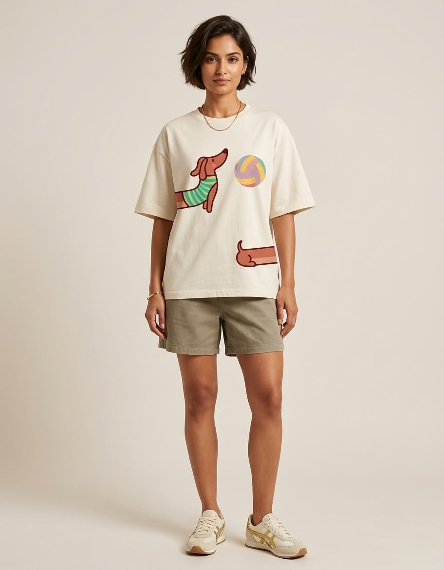 Full-length front view of a model wearing The Sabio oversized cream cotton t-shirt paired with olive shorts and sneakers.