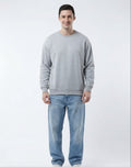 Front view of male model wearing The Sabio oversized heather grey fleece sweatshirt paired with light wash denim